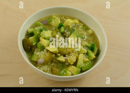 Homemade chunky avocado tomatillo salsa verde sauce or dip in white bowl Stock Photo