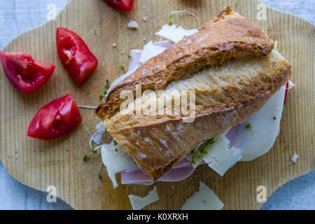rustic big ham sandwich on wooden board Stock Photo