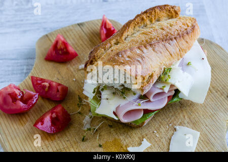 rustic big ham sandwich on wooden board Stock Photo
