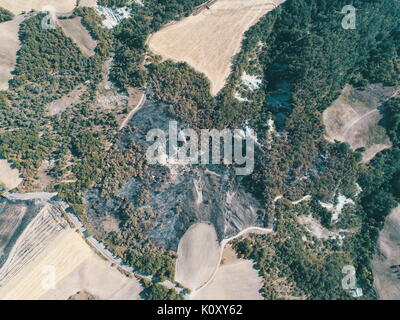 Arson:,Burnt ground due to forest fire damage, Burnt field in Reggio Emilia hills, Vedriano, Trinità Stock Photo