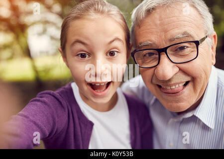 Disabled man and his granddaughter taking funny selfie Stock Photo