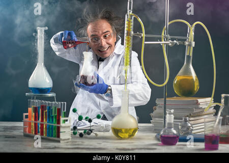 Crazy chemist doing experiment chemical laboratory Stock Photo