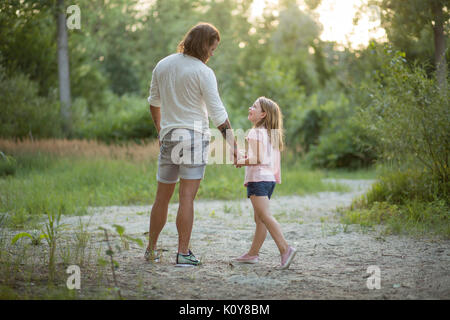 Father and daughter together in the forest Stock Photo