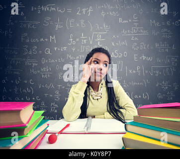 Female African pupil thinking about beautiful things while sitting in school desk Stock Photo