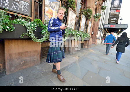 London, England, UK. Man wearing a kilt in Whitehall Stock Photo