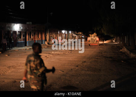 An Ethiopian soldier, as part of the African Union Mission in Somalia, walks through Baidoa, Somalia, on June 22 during a night patrol in the city. AMISOM Photo   Tobin Jones (14332233820) Stock Photo