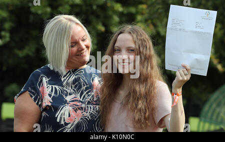 Millie Robson, 15, who was injured in the Manchester Bombings celebrates taking her GCSE English a year early, with her mother Marie, 43, at Woodham Academy in Newton Ayrcliffe. Stock Photo