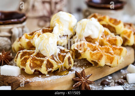 Homemade belgium waffers with ice cream, honey and coffee on old wooden background Stock Photo