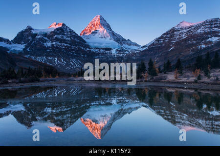 Mount Assiniboine reflected in Lage Magog at sunrise, Mount Assiniboine Provincial Park, Rocky Mountains, British Columbia, Canada. Stock Photo