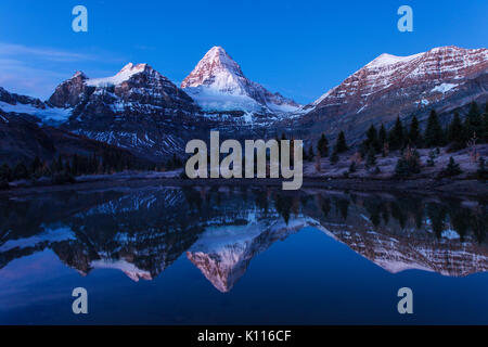 Mount Assiniboine reflected in a tarn near Lage Magog under the stars, Mount Assiniboine Provincial Park, Rocky Mountains, British Columbia, Canada. Stock Photo