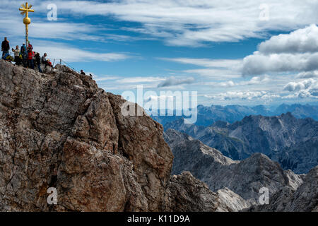 Tourists queue to get to the summit of the Zuspitze mountain on the Germany Austria border. At 2962m it is the highest mountain in Germany. Stock Photo