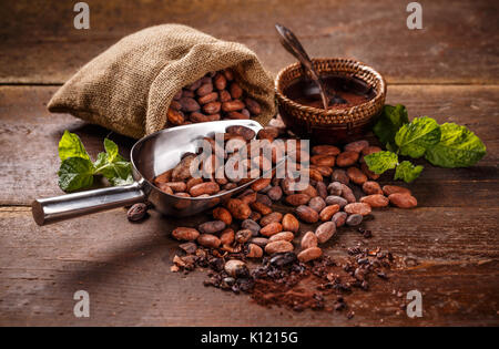 Cocoa concept with raw, peeled, and crushed Theobroma cacao cocoa beans Stock Photo