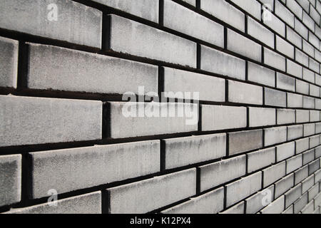 Brick wall in perspective, gray background Stock Photo