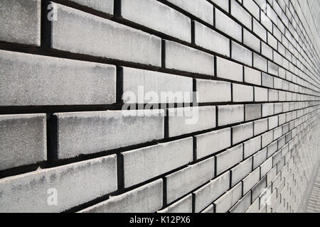 Brick wall in gray in perspective, construction background Stock Photo