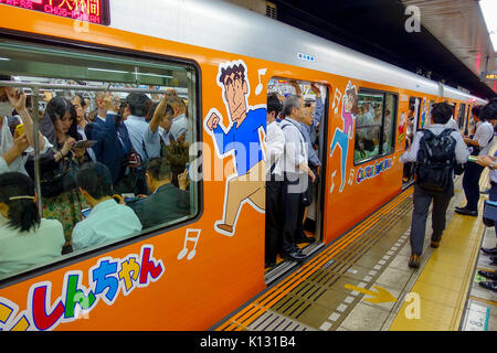 TOKYO, JAPAN - CIRCA MAY 2014: Crowd of people hurry at Ikebukuro station in Tokyo, Japan. Ikebukuru is the second-busiest railway station in the world Stock Photo