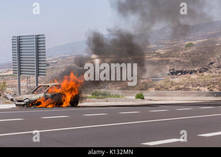 Opel Corsa car on fire by the roadside Stock Photo