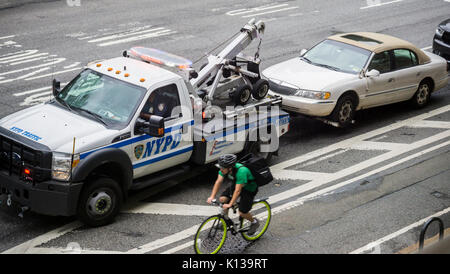 A driver gets their car towed in the Chelsea neighborhood of New York on Tuesday, August 15, 2017. ( © Richard B. Levine) Stock Photo