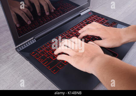 business hand typing keyboard of laptop on wood background Stock Photo