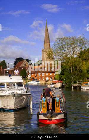 Narrow boat owner leaving his overnight mooring on the river Thames at Abingdon on Thames Oxfordshire England UK Stock Photo