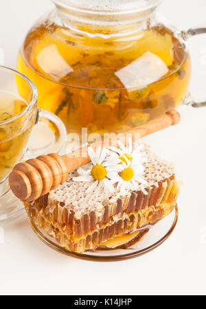 Honeycomb and chamomile tea on white Stock Photo