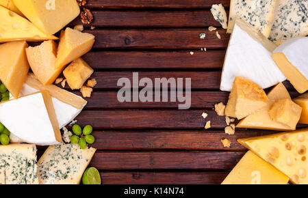 Different cheeses on wooden table Stock Photo