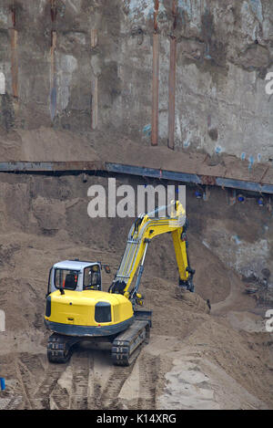 Excavator on a construction site digging an excavation Stock Photo