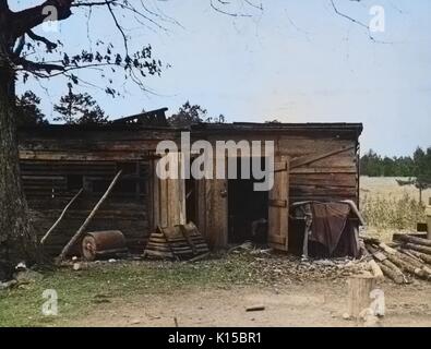 Dilapidated, one story wooden rural home on a farm at Crabtree Creek Recreational Project, Raleigh, North Carolina, 1936. From the New York Public Library. Note: Image has been digitally colorized using a modern process. Colors may not be period-accurate. Stock Photo