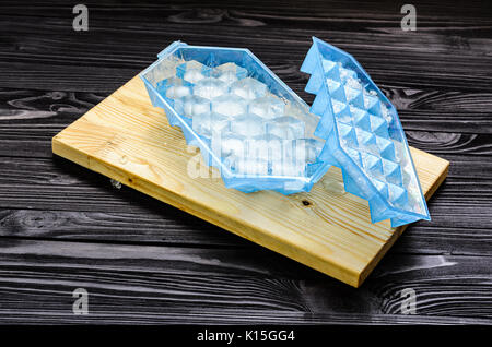 A blue plastic ice cube tray with frost on it isolated over a white  background, Stock image