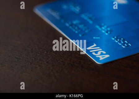 New york, USA - August 24, 2017: Blue visa card on wooden background close-up Stock Photo