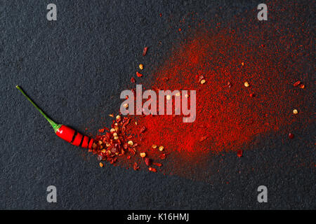 Chili, red pepper flakes and chili powder burst Stock Photo