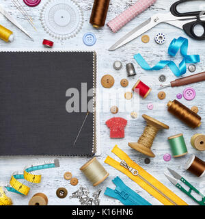 Overhead view of sewing tools and accessories on white painted wooden background Stock Photo