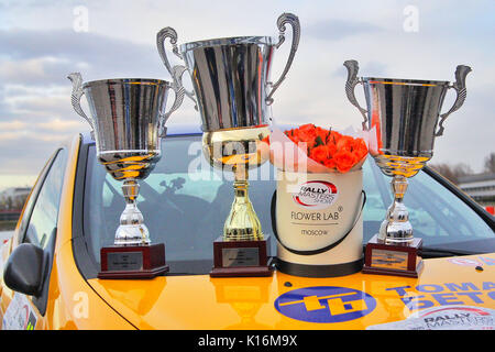 Moscow, Russia - Apr 18, 2015: Trophy cups and flowers stand on the hood of the Subaru Impreza after the Rally Masters Show 2015 at the Krylatskoye Di Stock Photo