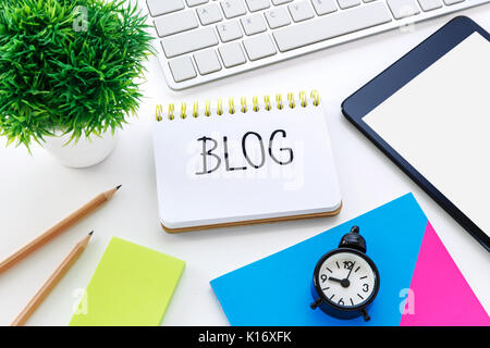 Notebook with blog word on computer desk with pencil notepad and clock Stock Photo