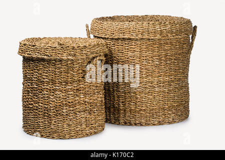 SET OF TWO LARGE ROUND NATURAL PLANT FIBER BRAIDED BASKET WITH HANDLES AND LID ISOLATED ON WHITE BACKGROUND Stock Photo