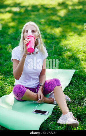 Image of sports woman drinking from bottle Stock Photo