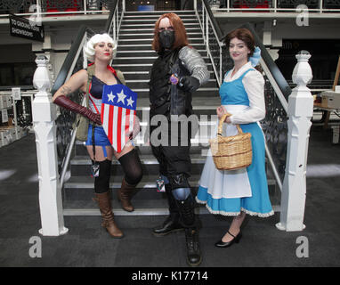 (left to right) Puddy Geeks as Captain America, Ash Lewis as Bucky Barnes and Holly Bubbles as Belle at the London Super Comic Con, at the Business Design Centre in London. Stock Photo