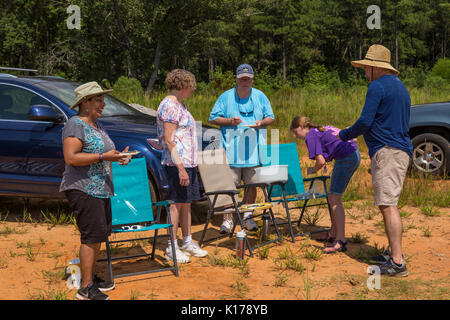 A group of eclipse watchers celebrate with an eclipse cake after the Great American Eclipse on August 21, 2017. Stock Photo