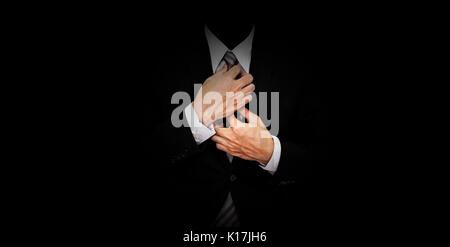 Businessman in black suit on panoramic black background Stock Photo
