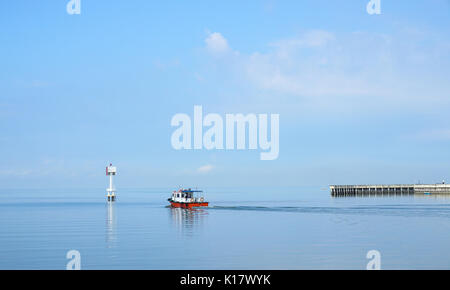 A ferry running on the sea in Malacca, Malaysia. Malacca was included in the list of UNESCO World Heritage Sites in 2008. Stock Photo