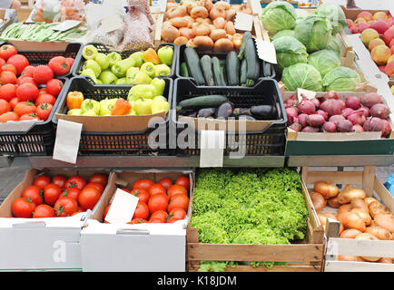 Fresh organic vegetables in crates on market stall