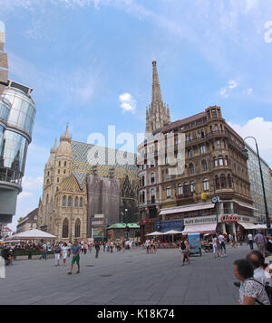 VIENNA, AUSTRIA - JULY 12; Stephansplatz square with St. Stephen cathedral and tourists walking around in Vienna, Austria - July 12, 2015: Famous hist Stock Photo