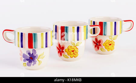 Lovely hand painted mugs isolated on white background Stock Photo
