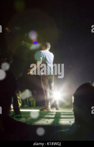 Back view of singer in night concert on stage Stock Photo - Alamy