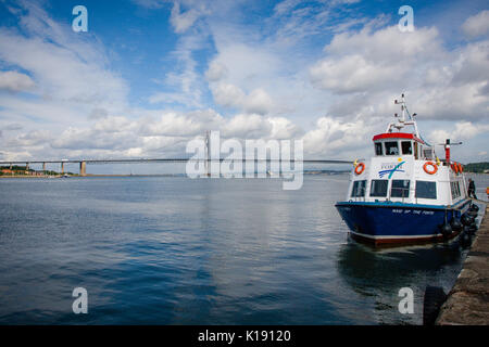 Maid of the Forth ferry docked on the Hawes Pier at the Firth of the Forth in South Queensferry with Forth Road Bridge in the background, Edinburgh Stock Photo