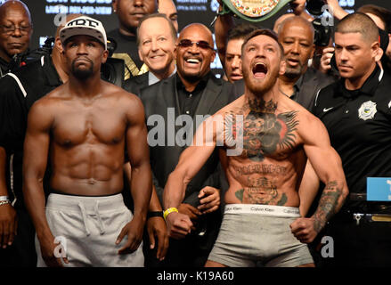 Las Vegas NV, USA. 25th Aug, 2017. (L-R) Floyd Mayweather Jr. poses off with Conor McGregor during todays weigh-In Friday at the T-Mobile Arena. McGregor will be fighting Floyd Mayweather Jr. August 26th at the T-Mobile arena in Las Vegas. This will be Floyd's 50th fight and his last.Photos by Gene Blevins/LA DailyNews/SCNG/ZumaPress. Credit: Gene Blevins/ZUMA Wire/Alamy Live News Stock Photo