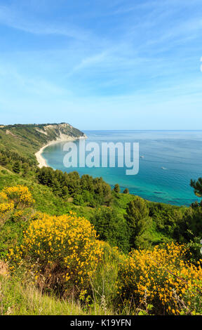 Summer Adriatic sea bay and blossoming Spiaggia Mezzavalle beach near Portonovo and Ancona towns in the Marche region. Italy, Conero Riviera. People u Stock Photo
