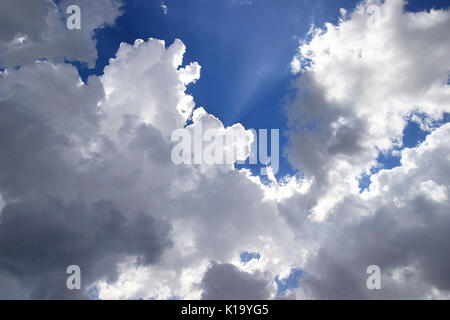 Clouds, sun rays and blue sky Stock Photo