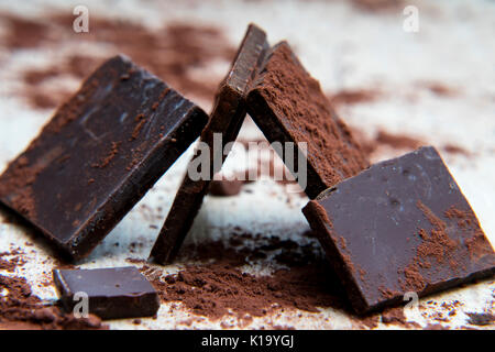 Chocolate structure covered with cocoa powder on wood textured table Stock Photo