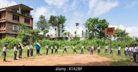 School children in the rural town of Dhulikhel Nepal playing games during a break from the classroom Stock Photo