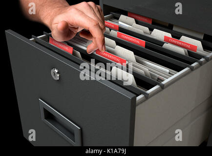 A male hand searching through confidential related documents in a filing cabinet drawer Stock Photo